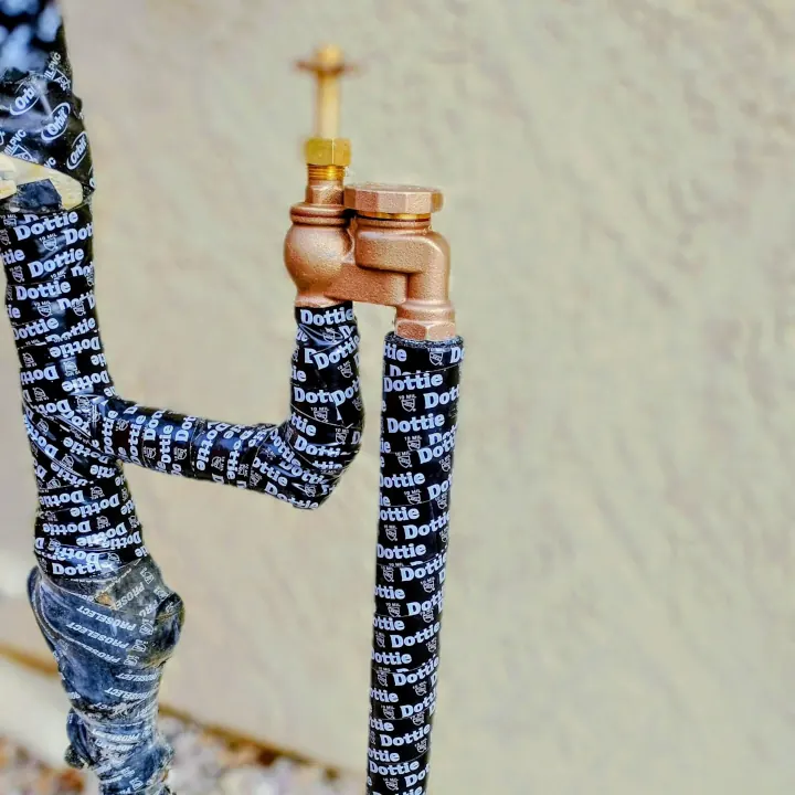 Close up image of an irrigation pipe against a wall